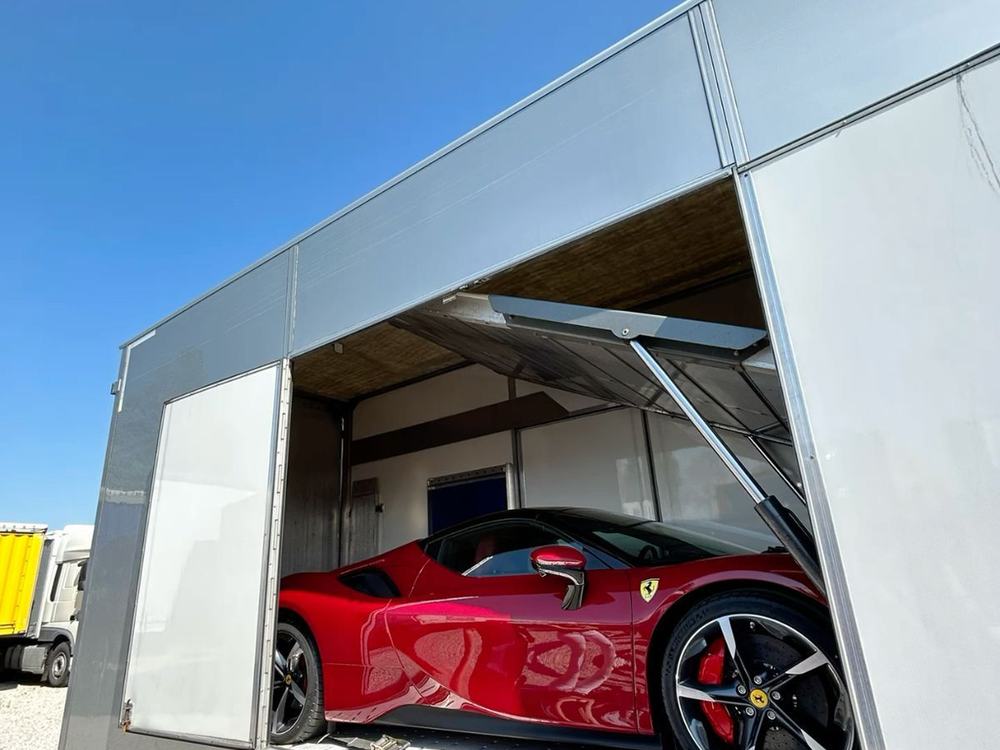 Ferrari secured inside an enclosed transport trailer