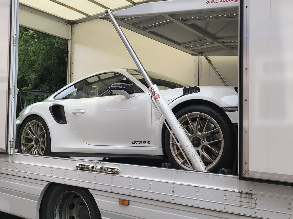 Porsche loaded in an enclosed trailer by an Edgebay carrier
