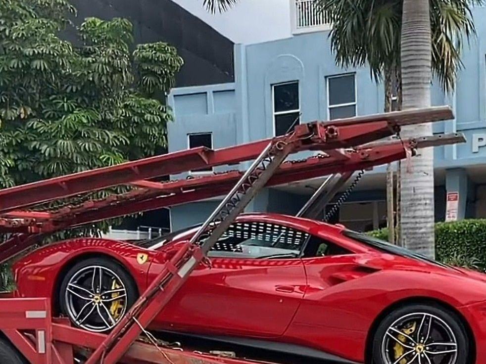 Ferrari loaded on an open flatbed carrier