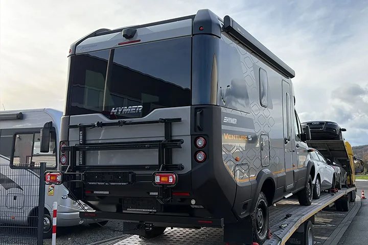 Hymer motorhome loaded on a flatbed carrier for transport